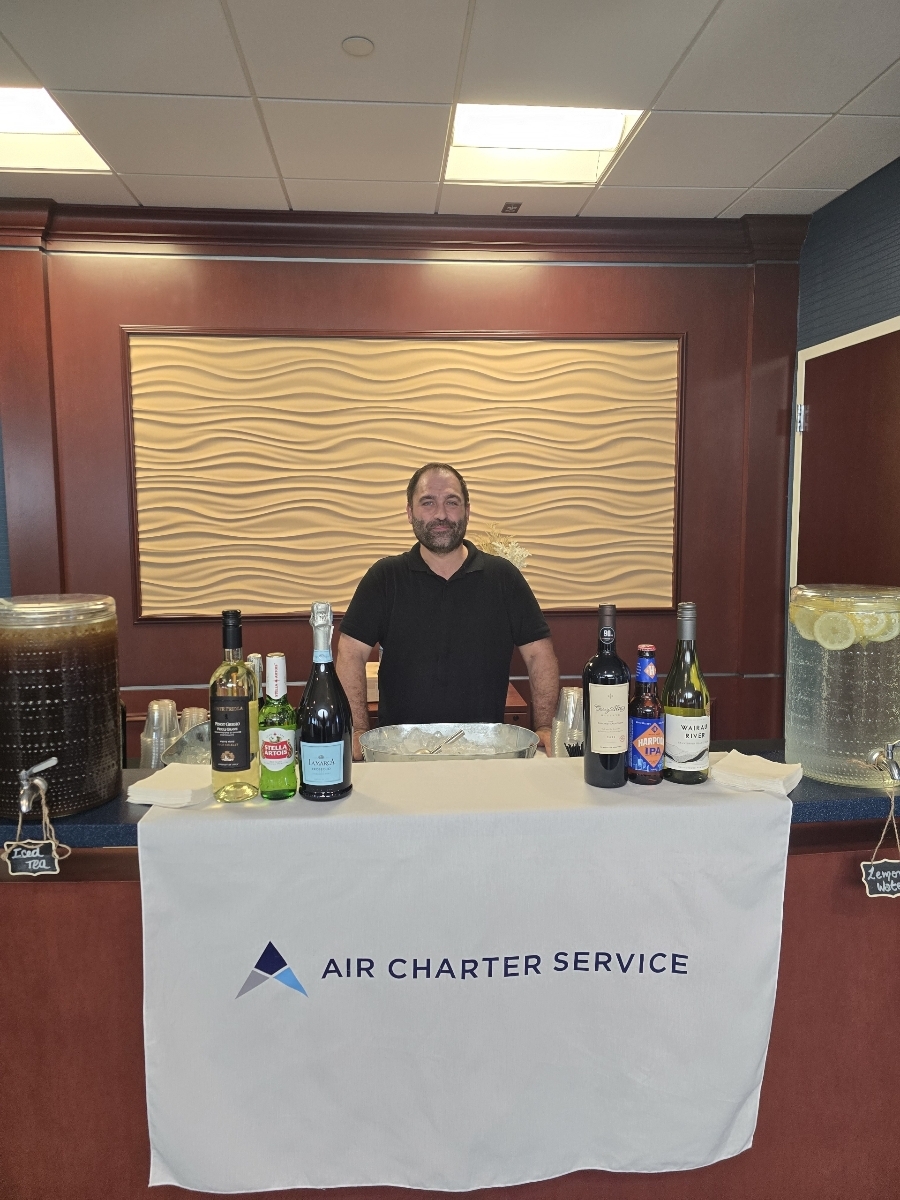Bartender standing behind a clean service table