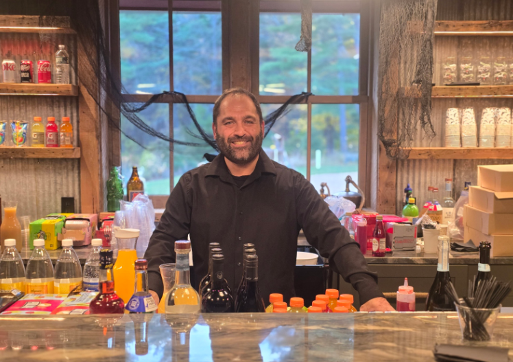 Bartender working behind a colorful cocktail station