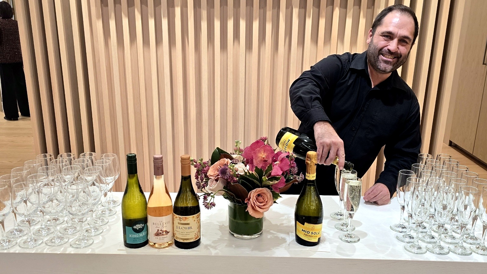 Bartender pouring champagne for private event guests